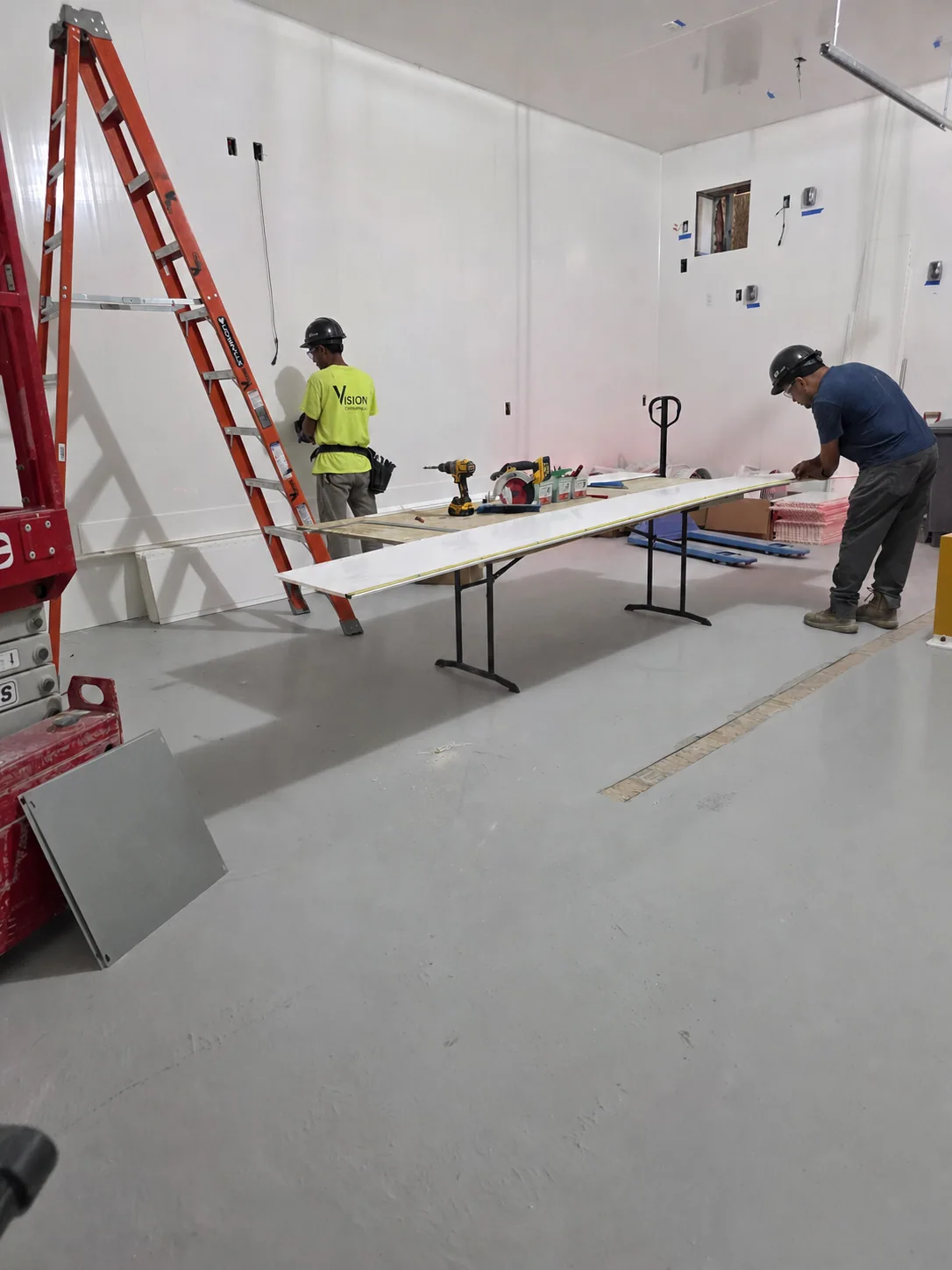 Visions employees completing an interior facility fit-out in proper PPE